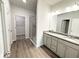 Bright bathroom featuring a double vanity, glass shower, and walk-in closet access at 5295 Greenway Dr, Villa Rica, GA 30180
