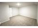 A well-lit bedroom with neutral carpet flooring and a door on the left at 5295 Greenway Dr, Villa Rica, GA 30180