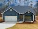 Charming home with a two-car garage, inviting entryway, and well-manicured front yard at 5295 Greenway Dr, Villa Rica, GA 30180