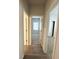 Hallway with multiple doorways to bedrooms, offering a glimpse of the interior layout at 5295 Greenway Dr, Villa Rica, GA 30180