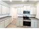 Modern kitchen features gray cabinetry, stainless steel appliances, and granite countertops at 5295 Greenway Dr, Villa Rica, GA 30180