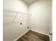 A well-lit laundry room with plank flooring and ample shelf space at 5295 Greenway Dr, Villa Rica, GA 30180