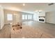 Spacious living room with lots of natural light, neutral paint, fireplace, and large island with sink at 5295 Greenway Dr, Villa Rica, GA 30180