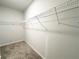 A corner view of carpeted walk-in closet with white wire shelving at 5295 Greenway Dr, Villa Rica, GA 30180