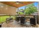 Back porch with wicker furniture, wooden flooring and ceiling, and backyard view at 1228 Ladd Sw St, Atlanta, GA 30310