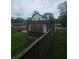 Fenced backyard featuring a cozy covered patio with latticework and white curtains at 1228 Ladd Sw St, Atlanta, GA 30310
