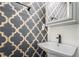 Stylish bathroom featuring a unique wallpaper and a wall mounted sink at 1228 Ladd Sw St, Atlanta, GA 30310