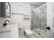 Bathroom featuring a shower with marble tile surround, and stylish dark fixtures at 1228 Ladd Sw St, Atlanta, GA 30310