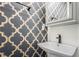 Stylish bathroom featuring a unique patterned wallpaper, modern sink, and elegant mirror at 1228 Ladd Sw St, Atlanta, GA 30310