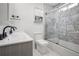 Bathroom featuring double sinks and a shower with marble tile surround at 1228 Ladd Sw St, Atlanta, GA 30310