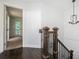 Hallway with hardwood floors, wrought iron banister, and stylish light fixture at 1228 Ladd Sw St, Atlanta, GA 30310
