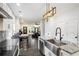 Modern kitchen with an open layout, granite countertops, stainless steel sink, and a unique light fixture at 1228 Ladd Sw St, Atlanta, GA 30310
