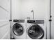 Modern laundry room featuring an Electrolux front load washer and dryer set and tile floor at 1228 Ladd Sw St, Atlanta, GA 30310