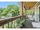 Inviting covered porch with seating, ceiling fan, and lush green views at 1228 Ladd Sw St, Atlanta, GA 30310
