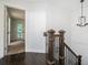 Bright staircase features dark wood floors, an ornate wrought iron railing, and a modern chandelier at 1228 Ladd Sw St, Atlanta, GA 30310