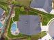 Aerial view of a home showcasing the backyard, pool, firepit area, and lush landscaping at 1974 Hosack Sw Hl, Marietta, GA 30064