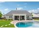Gorgeous backyard with a gunite pool, covered patio, and manicured lawn at 1974 Hosack Sw Hl, Marietta, GA 30064