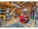 Unfinished basement with exposed wooden beams, lots of storage, shelving, and workbench at 1974 Hosack Sw Hl, Marietta, GA 30064