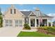 Charming craftsman style home featuring a brick and siding facade, attached garage, and inviting front porch with manicured lawn at 1974 Hosack Sw Hl, Marietta, GA 30064