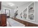 Elegant foyer with hardwood floors, staircase, and custom built-in shelving, creating a warm and inviting entrance at 1974 Hosack Sw Hl, Marietta, GA 30064