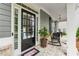 Inviting front porch with rocking chairs and a decorative door, perfect for relaxing and enjoying the outdoors at 1974 Hosack Sw Hl, Marietta, GA 30064