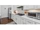Modern kitchen featuring white cabinets, stainless steel appliances, quartz countertops, and tile backsplash at 1974 Hosack Sw Hl, Marietta, GA 30064