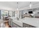 Open kitchen featuring a large island with seating, stainless steel appliances, and seamless flow into living spaces at 1974 Hosack Sw Hl, Marietta, GA 30064