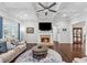 Cozy living room with a brick fireplace, hardwood floors, and ample natural light at 1974 Hosack Sw Hl, Marietta, GA 30064