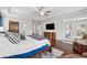 Spacious main bedroom with hardwood floors, ceiling fan, TV and access to a balcony at 1974 Hosack Sw Hl, Marietta, GA 30064