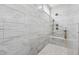 Close up of the large marble tiled walk-in shower featuring dual shower heads and a built in bench at 1974 Hosack Sw Hl, Marietta, GA 30064