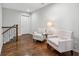 Cozy upstairs sitting area with hardwood floors, staircase and natural light at 1974 Hosack Sw Hl, Marietta, GA 30064