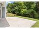 View of the large patio in a spacious backyard surrounded by mature trees at 231 Clarion Rd, Lawrenceville, GA 30043