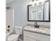 Bathroom features vanity with granite countertop, a toilet, and shower-tub combo at 231 Clarion Rd, Lawrenceville, GA 30043