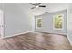 Spacious bedroom with wood-look floors, neutral paint, and large windows at 231 Clarion Rd, Lawrenceville, GA 30043