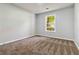 Bright bedroom with plush carpet and a window offering natural light at 231 Clarion Rd, Lawrenceville, GA 30043