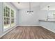 Charming dining area with wood-look floors, modern lighting, and open access to the kitchen at 231 Clarion Rd, Lawrenceville, GA 30043
