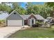 Charming single-story home with gray siding, brick accents, and a well-manicured front yard at 231 Clarion Rd, Lawrenceville, GA 30043