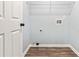 Laundry room with wood-look vinyl flooring and convenient utility connections at 231 Clarion Rd, Lawrenceville, GA 30043