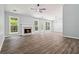 Spacious living area boasts a fireplace, modern ceiling fan, and stunning wood-look flooring at 231 Clarion Rd, Lawrenceville, GA 30043
