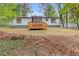 Rear view of the home featuring a screened in porch and back deck in the home's backyard at 3216 Montheath Ct, Duluth, GA 30096