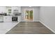 Open dining area with sliding glass doors to deck and a view of the kitchen with stainless steel appliances at 3216 Montheath Ct, Duluth, GA 30096