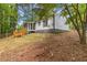 View of the back exterior of the home showcasing a wooden deck and screened in porch at 3216 Montheath Ct, Duluth, GA 30096