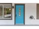 Close-up of the bright blue front door, accented by a glass window and dark hardware, set against white siding at 3216 Montheath Ct, Duluth, GA 30096