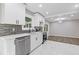 Open kitchen with stainless appliances, stone countertops, backsplash, and adjacent dining area at 3216 Montheath Ct, Duluth, GA 30096