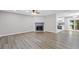 Spacious living room showcasing new flooring, a modern fireplace, and abundant natural light, creating an inviting atmosphere at 3216 Montheath Ct, Duluth, GA 30096