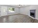 Bright living room featuring stylish flooring, a cozy fireplace, and an adjacent doorway, perfect for entertaining guests at 3216 Montheath Ct, Duluth, GA 30096