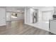 Open-concept living space featuring new floors, a light gray color palette, and seamless flow between the kitchen and living areas at 3216 Montheath Ct, Duluth, GA 30096