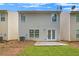 Rear exterior view of a townhome featuring a small patio and grassy area at 50 Fieldview Ln, Covington, GA 30016