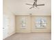 A spacious bedroom with neutral carpet, ceiling fan, and two large windows at 50 Fieldview Ln, Covington, GA 30016