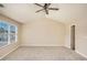 A spacious bedroom with neutral carpet, ceiling fan, and a large window at 50 Fieldview Ln, Covington, GA 30016